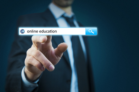 Businessman hand touching online education text on virtual screenの写真素材