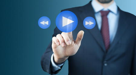 businessman  hand press play button on touch screen