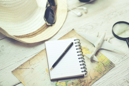 airplane and hot on map on wooden tableの写真素材