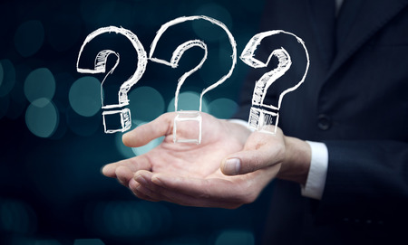 businessman hand  question mark on bokeh backgroundの写真素材