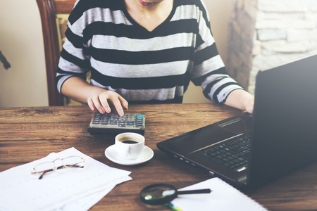 Woman using a calculator in an office