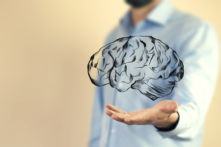 Close up of businessman hand holding brain in palmの写真素材