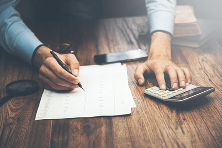 business man hand calculator, sheet and documentsIreri Gnumner