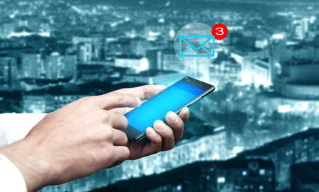 man hand phone with message in city background