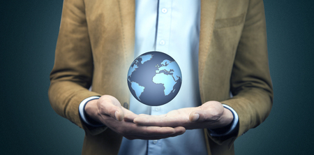 business man hand holding global planet in screenの写真素材