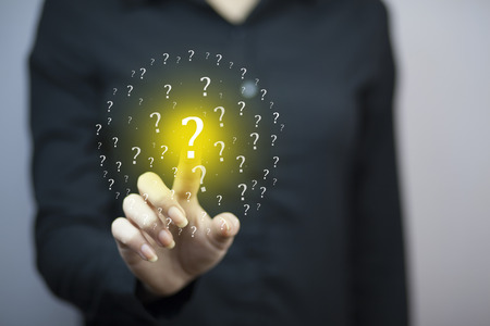 Question Marks with businesswoman on dark vintage background