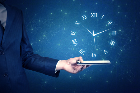 young businessman hand holding phone with clock in screenの写真素材