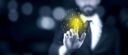 Question Marks with businessman on dark vintage background