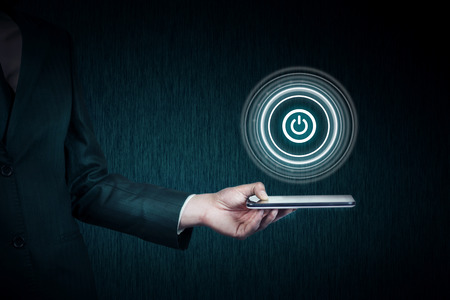 young businessman hand  tablet with power button in screen