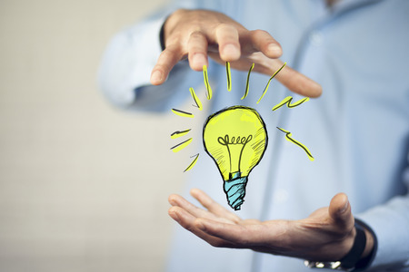 business man hand idea with light bulbの写真素材