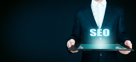 Businessman hand touching SEO button on virtual screenの写真素材