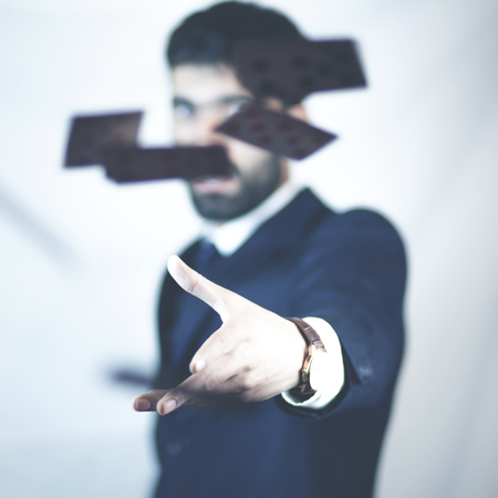 man throwing playing cards up in the airの写真素材