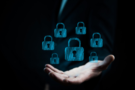 businessman hand lock in screen in dark backgroundの写真素材