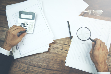Businessman reading documents with  analyzing a finance agreementの写真素材