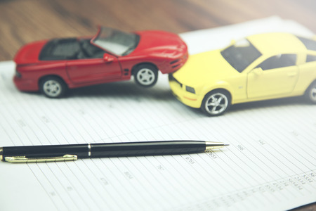yellow and red car model  on documents in ofice tableの写真素材