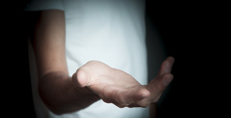 Open palm hand on dark backgroundの写真素材