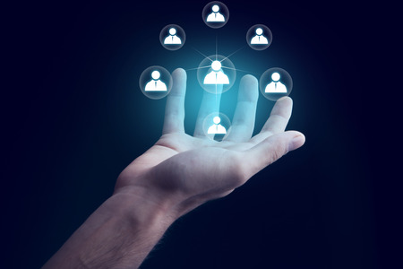 businessman hand with network in screen on dark backgroundの写真素材