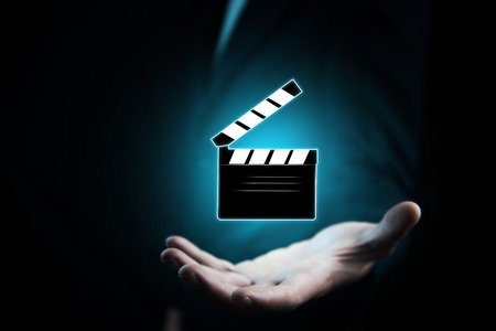 man hand with a movie clapper slapstickの写真素材