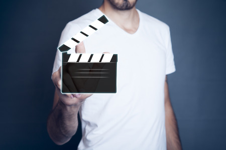 man hand with a movie clapper slapstickの写真素材