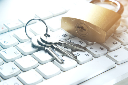Lock and key on an white keyboard