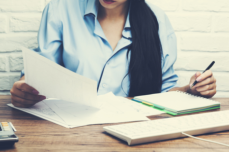 woman hand document and notepad with keyboard in tableの写真素材