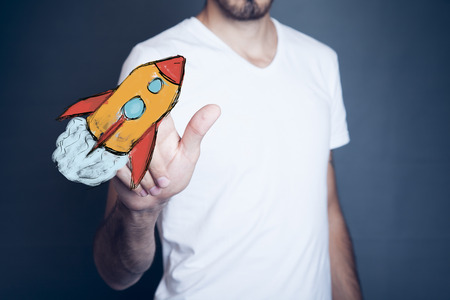 Businessman  hand red  rocket on white backgroundの写真素材