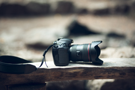 new camera and lens on wood in forestの写真素材