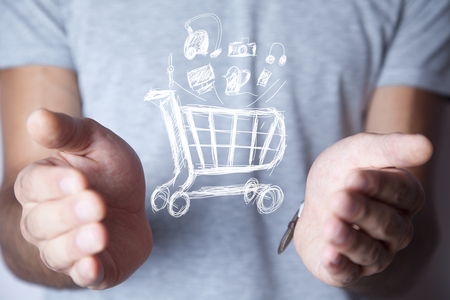 businessman hand basket in screen on dark backgroundの写真素材