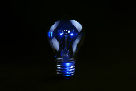 idea text on light bulb on dark background