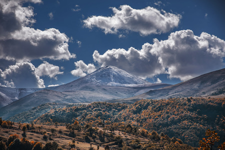 beautiful mountains in autumn in dark cloudsの写真素材