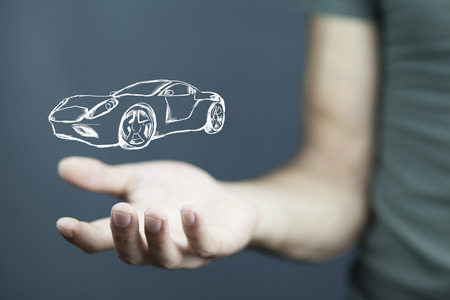 Close up of businessman hand car icon on virtual screenの写真素材