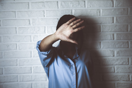 woman gesturing to stop isolated on a dark background