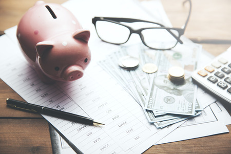 piggy bank, money and calculator on dacumentの写真素材