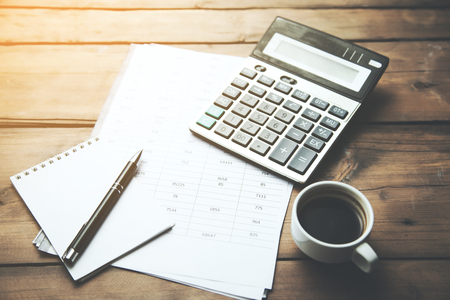 calculator with cup of coffee on financial newspaperの写真素材