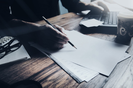 businessman hand document with computer in office