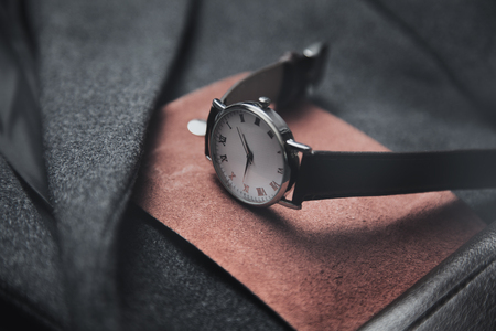 watch on wallet on gray coat backgroundの写真素材