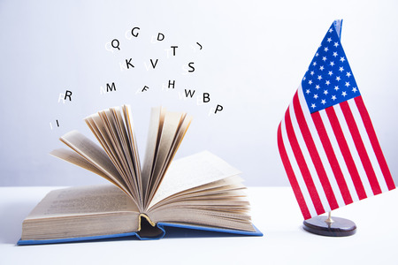 Composition of American flag and  book on white backgroundの写真素材