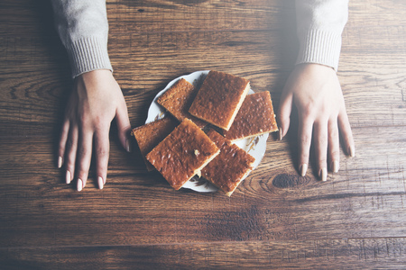 dieting woman hand  with cakes
