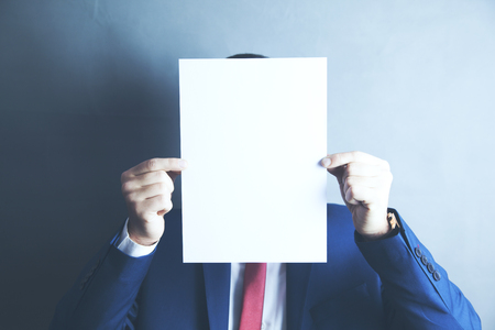 businessman hand empty paper in faceの写真素材