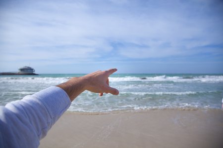 man finger pointing to the sea. Tourism concept.の写真素材