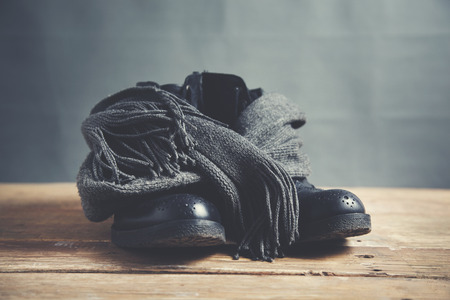 man shoes and scarf on wooden table backgroundの写真素材