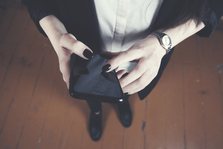 young business woman hand holding  smart phoneの写真素材