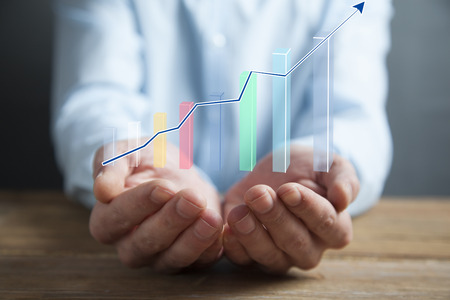 business man holding a hand-drawn bar graph in his hand
