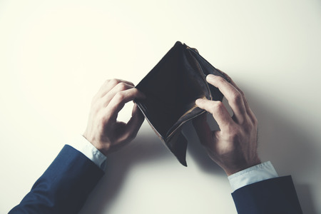portrait of a man showing empty wallet
