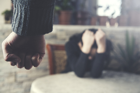 man beat sad woman on color backgroundの写真素材
