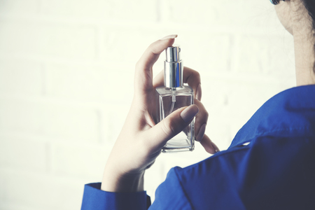 woman hand perfume in brick wall backgroundの写真素材
