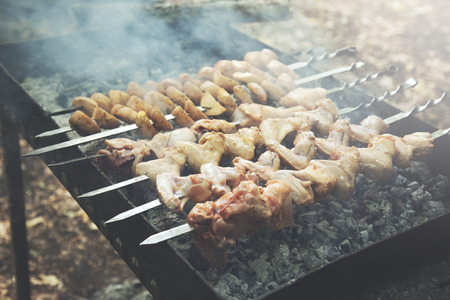 steak shishkabob skewers cooking on flaming grillの写真素材