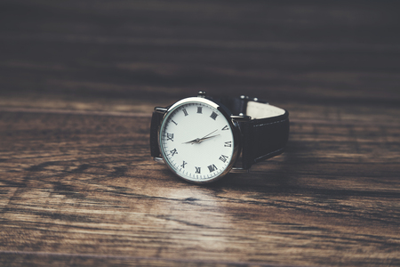 man elegant watch on the wooden tableの写真素材