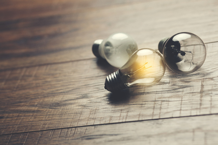 bulb or idea on wooden table backgroundの写真素材