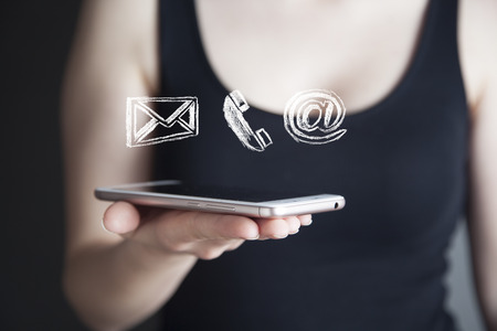 businesswoman hand phone with  contact icons in screenの写真素材
